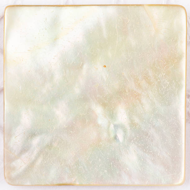 beautiful pearl white plate beautiful natural light with iridescent nacre pearl shimmering in the form of a square plate for mosaic mother of pearl stock pictures, royalty-free photos & images
