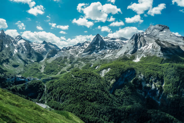 Beautiful photo of mountains contrasting the white color of the snow with the green of the vegetation stock photo