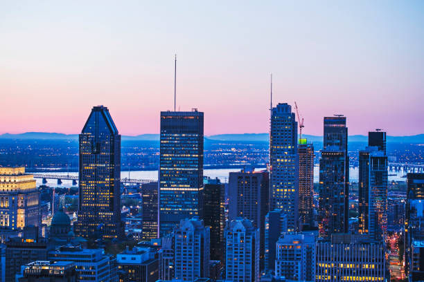Beautiful red and blue sky and sunrise light over Montreal city in the morning time. Amazing view from Mont-Royal with modern architecture. stock photo