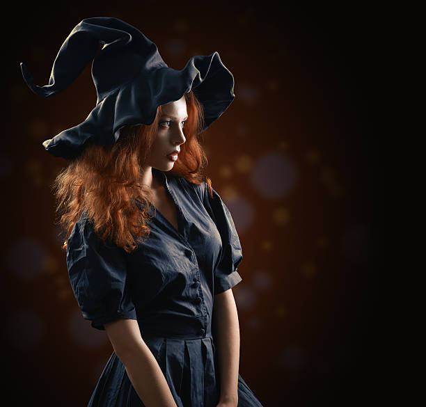 beautiful red-haired girl in the witch costume beautiful red-haired girl in the witch costume on a red blurred background ugly skinny women stock pictures, royalty-free photos & images