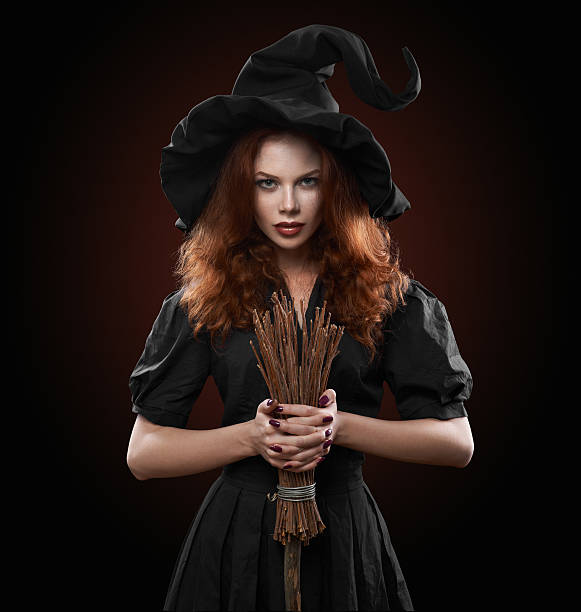 beautiful red-haired girl in the witch costume beautiful red-haired girl in the witch costume on a red background ugly skinny women stock pictures, royalty-free photos & images