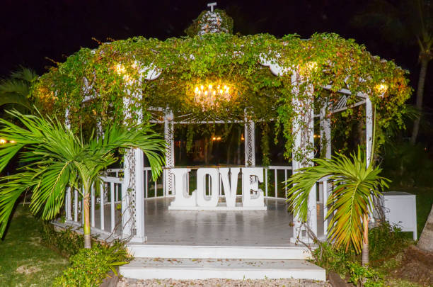 Beautiful romantic outdoor wedding setup with love sign and gazebo stock photo