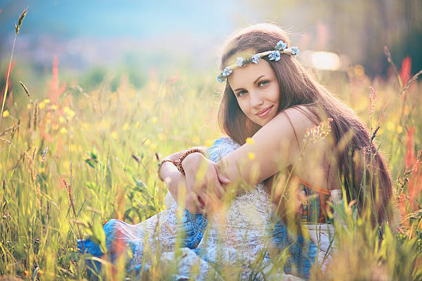 Beautiful romantic woman in flower field stock photo
