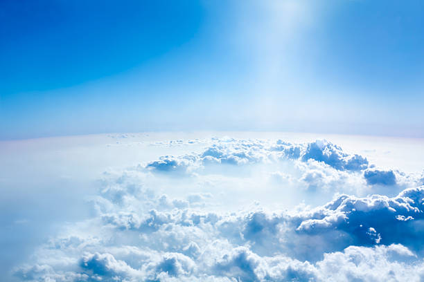 Beautiful sky and above cloud panorama from the airplane. sunlight comes in the circle of cloud like a magic.  atmosphere stock pictures, royalty-free photos & images