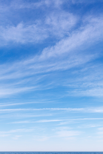 Beautiful sky over the sea with cirrus clouds. Background image. Horizon line