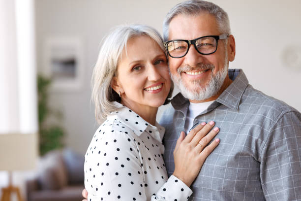 Beautiful smiling senior family couple husband and wife looking at camera with love stock photo