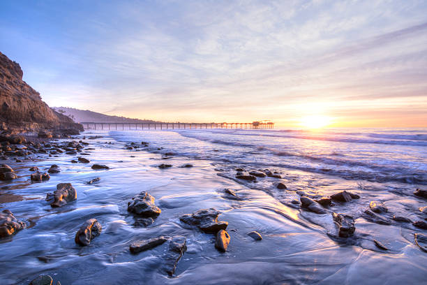 Beautiful southern California coastline at sunset Colorfully vivid scenic southern California beach featuring Scripps pier in La Jolla at sunset with beautiful relfections low tide stock pictures, royalty-free photos & images