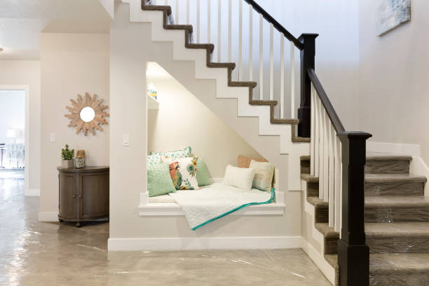 Beautiful stairway leading from basement to upstairs Reading nook underneath stairs with perfect ambience below stock pictures, royalty-free photos & images