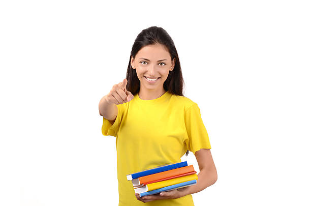 Beautiful student pointing in front to you. stock photo