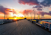 istock Beautiful sunrise over a wooden pier on the Baltic Sea. Sopot, Poland. 1384718521