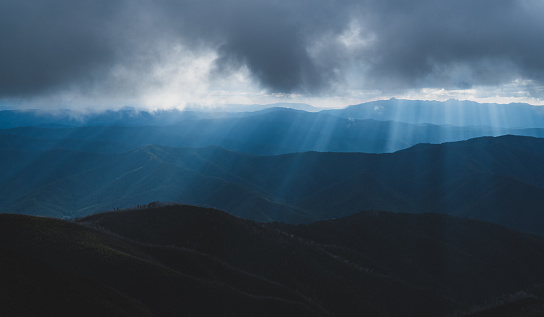 Beautiful Sunset light breaking through the clouds in the mountains of Victoria