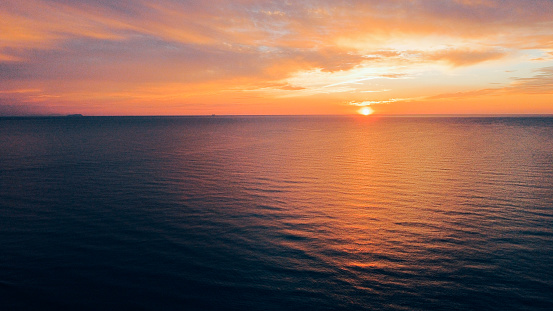 Beautiful sunset over sea, aerial view. Evening seascape, drone photography.