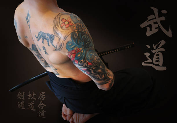 Beautiful Tattooed Yakuza's Body Tattooed naked samurai's revenge. Brave samurai and his katana sword in the japan dojo. bushido lifestyle stock pictures, royalty-free photos & images