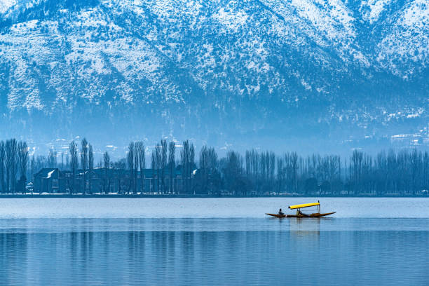 A beautiful view of Dal Lake in winter, Srinagar, Kashmir, India. A view of Dal Lake in winter, and the beautiful mountain range in the background in the city of Srinagar, Kashmir, India. srinagar stock pictures, royalty-free photos & images