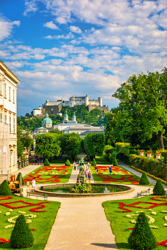 Beautiful view of famous Mirabell Gardens with the old historic Fortress Hohensalzburg in the background in Salzburg, Austria. Famous Mirabell Gardens with historic Fortress in Salzburg, Austria.