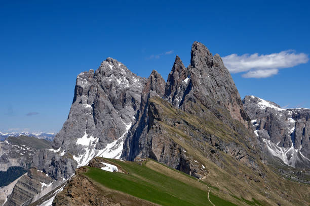 Beautiful view of the top of Mount Seceda in early summer with towering rock forms and meadows in the Italian Dolomites stock photo