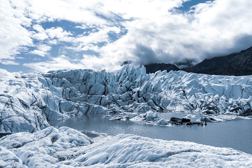 beautiful view on melting glacier blue ice with mountains around Alaska USA