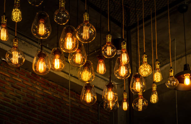 Beautiful vintage luxury light bulb hanging decor glowing in dark. House interior of loft and rustic style. Beautiful vintage luxury light bulb hanging decor glowing in dark. Retro filter effect style. Blend of history and modern. light bulb filament stock pictures, royalty-free photos & images
