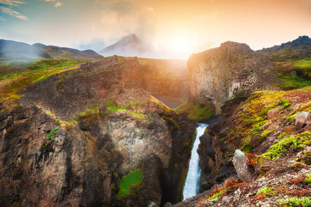 Beautiful waterfall in Greenland Beautiful waterfall in the mountains at sunset. Disco island, west coast of Greenland greenland stock pictures, royalty-free photos & images