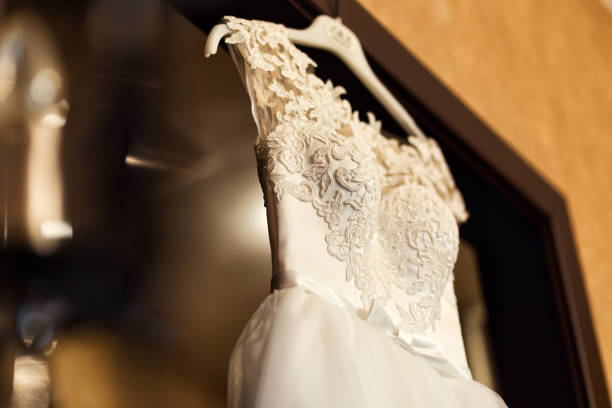 beautiful wedding dress hanging in the room, bridal accessories, wedding European, American Wedding stock photo