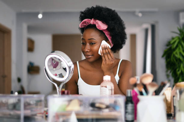 Beautiful woman cleaning her face with a face cloth. Beautiful woman cleaning her face with a face cloth. washcloth stock pictures, royalty-free photos & images