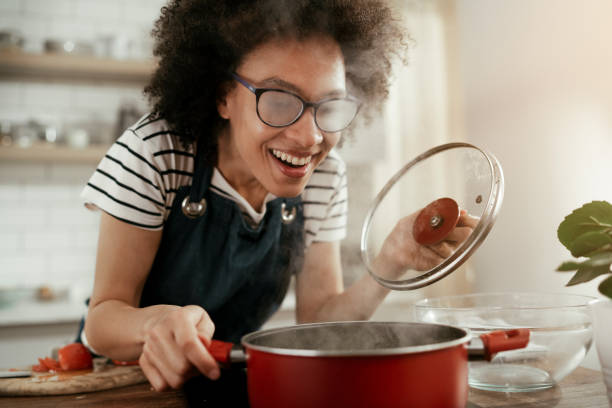 Beautiful woman cooking at home. stock photo