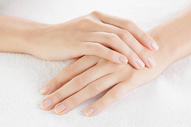 Beautiful woman hands are on a towel stock photo