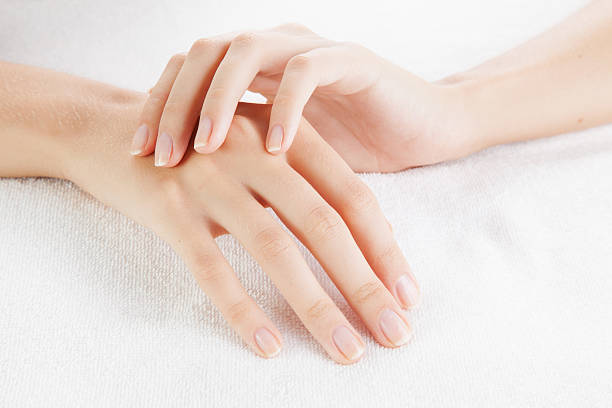 Beautiful woman hands are on a towel stock photo
