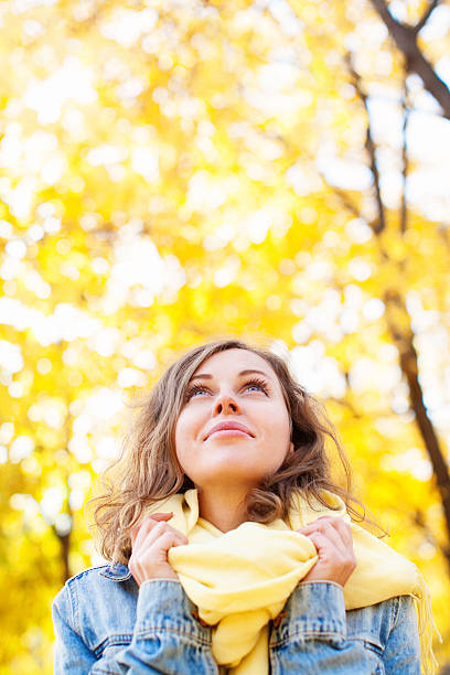 Beautiful woman in autumnal park stock photo