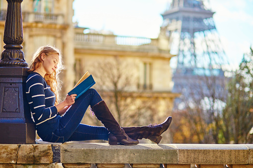 Beautiful woman in Paris, reading a book stock photo