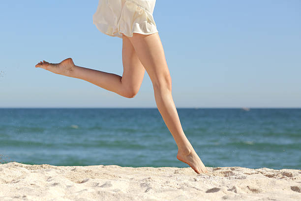 Beautiful Fit Woman Jumping At The Beach Near Stock Photo 