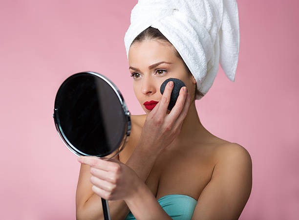 Beautiful woman removing makeup stock photo