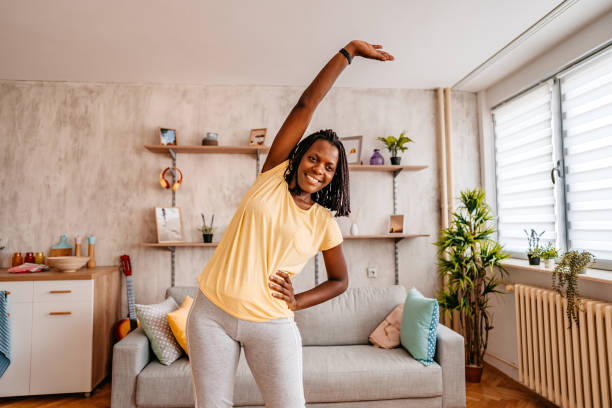 Beautiful woman stretching before training at home stock photo