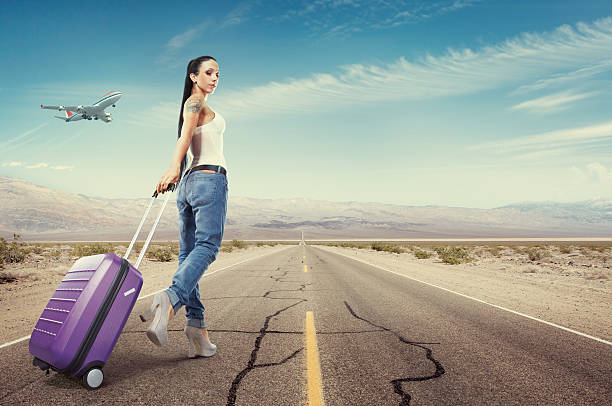 Beautiful woman traveling with luggage stock photo
