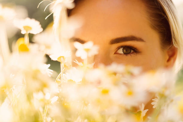 Beautiful woman with chamomile flowers stock photo