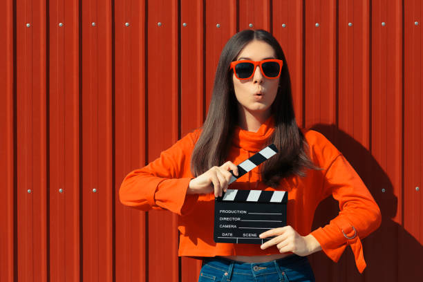 Beautiful Woman with Cinema Clapper on Red Background Cool model girl with film slate at casting audition clapboard photos stock pictures, royalty-free photos & images