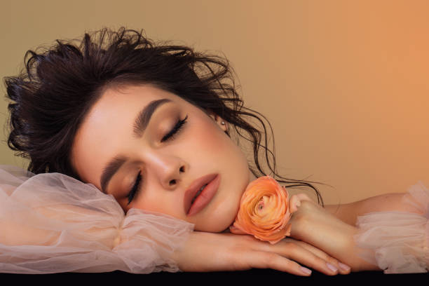Beautiful woman with flower and perfect make-up stock photo