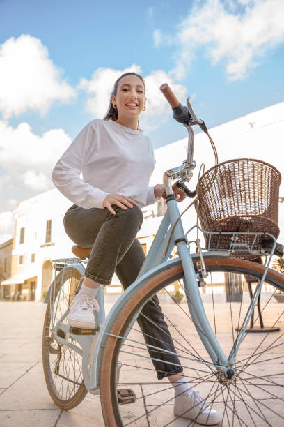 Beautiful woman with her bicycle outdoors stock photo