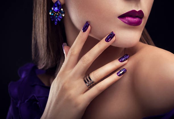 Beautiful woman with perfect make-up and manicure wearing jewellery Beautiful woman with perfect make-up and manicure wearing jewellery on black background gold ring on finger stock pictures, royalty-free photos & images