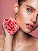istock Beautiful woman with pink rose 1277111725