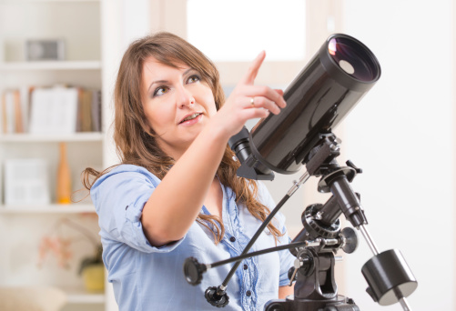 Beautiful woman with telescope