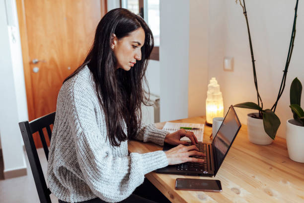 Beautiful woman working from home stock photo