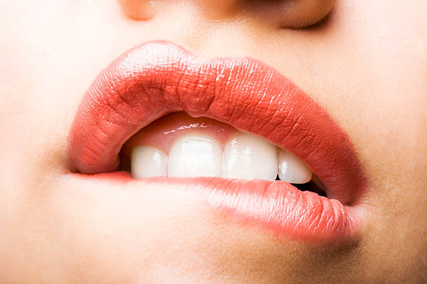 красивые женские губы - woman biting lips стоковые фото и изображения.