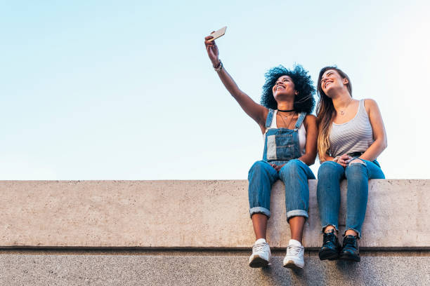 Beautiful women taking a self portrait in the Street. Beautiful women taking a self portrait in the Street. Youth concept. teenage girls photos stock pictures, royalty-free photos & images