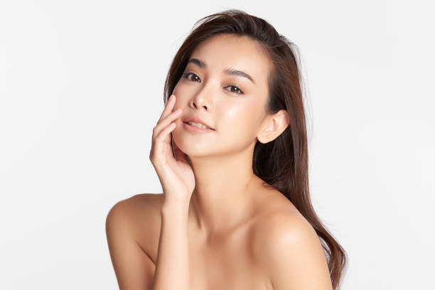 Beautiful young asian woman with clean fresh skin on white background, Face care, Facial treatment, Cosmetology, beauty and spa, Asian women portrait. Beautiful young asian woman with clean fresh skin on white background, Face care, Facial treatment, Cosmetology, beauty and spa, Asian women portrait. beautiful asian woman face stock pictures, royalty-free photos & images