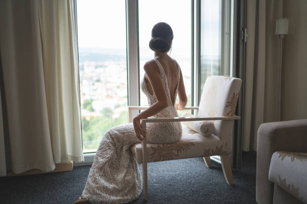 Beautiful young bride posing in hotel apartment on wedding day stock photo