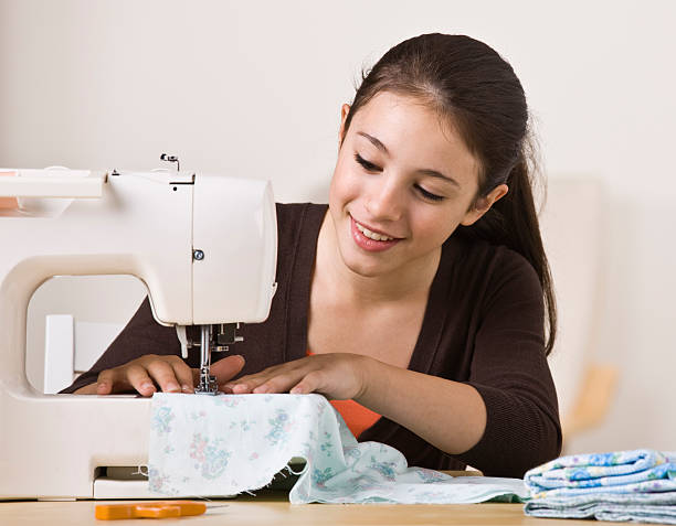 Beautiful Young Girl Sewing stock photo