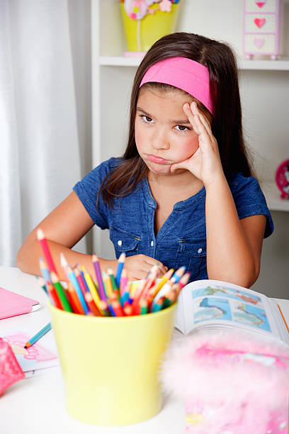 Beautiful young student hates learning stock photo