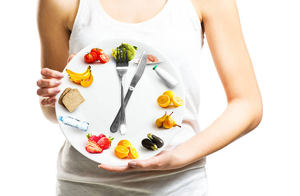 Beautiful young woman holding a plate with food stock photo