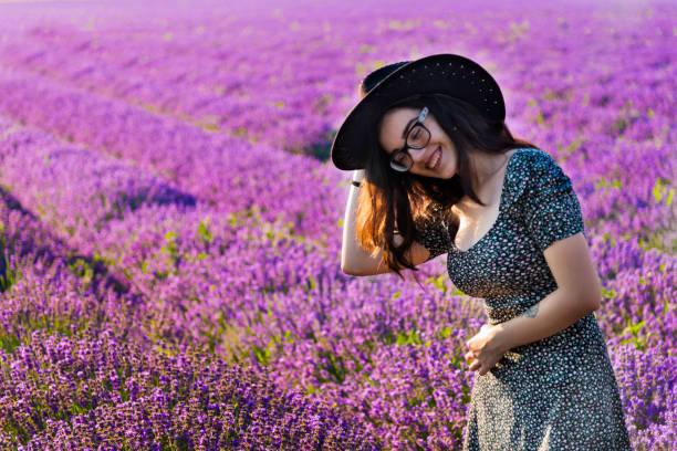 Beautiful young woman on lavender field stock photo
